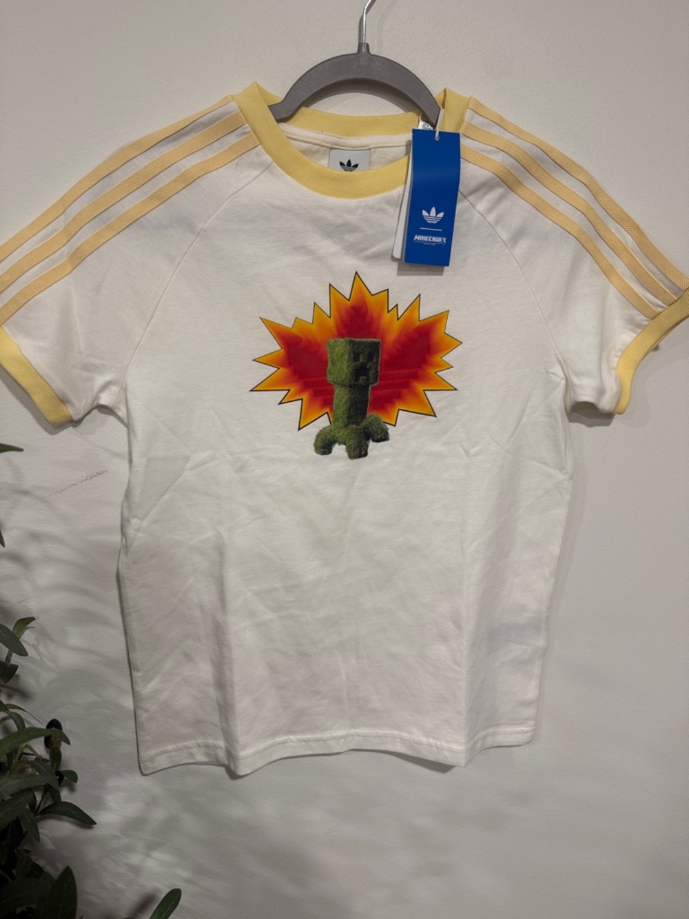 adidas White Tee with Yellow Trim and Red-Orange Burst Graphic